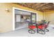 View from patio into primary bedroom with neutral colors and tiled floor at 472 Sandy Hook Rd, Treasure Island, FL 33706