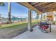 Outdoor patio with seating area overlooking the tennis court at 472 Sandy Hook Rd, Treasure Island, FL 33706