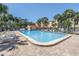 Community pool surrounded by lounge chairs and palm trees for a relaxing atmosphere at 472 Sandy Hook Rd, Treasure Island, FL 33706
