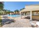Community pool with covered lounge area, chairs, and tropical landscaping at 472 Sandy Hook Rd, Treasure Island, FL 33706