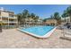 A clean, inviting community pool surrounded by lounge chairs, perfect for relaxation at 472 Sandy Hook Rd, Treasure Island, FL 33706