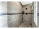 Walk in shower with tile walls, pebble floor, and modern shower head at 472 Sandy Hook Rd, Treasure Island, FL 33706