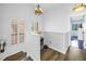 Bright stairway with hardwood flooring and modern chandelier lighting at 472 Sandy Hook Rd, Treasure Island, FL 33706