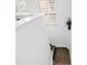 Bright white stairwell featuring wood stairs and a sunlit window at 472 Sandy Hook Rd, Treasure Island, FL 33706
