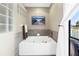 Bathroom tub with tile surround and garden window at 472 Sandy Hook Rd, Treasure Island, FL 33706