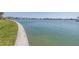 Waterfront view with lush green grass perfect for a stroll along the coast at 472 Sandy Hook Rd, Treasure Island, FL 33706