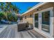 Charming backyard featuring a spacious deck, comfortable seating, and lush tropical landscaping for outdoor enjoyment at 508 N Mayo St, Crystal Beach, FL 34681