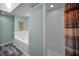 This bathroom features a large tub, glass shelving, neutral walls, and a sleek white shower, offering a spa-like experience at 508 N Mayo St, Crystal Beach, FL 34681