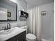 Charming bathroom with a decorative shelf, vanity, and tiled shower at 508 N Mayo St, Crystal Beach, FL 34681