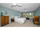 Bright main bedroom with ensuite bathroom, ceiling fan, and a window with a view at 508 N Mayo St, Crystal Beach, FL 34681