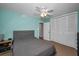 Cozy bedroom with a bed, ceiling fan, closet, and adjacent bathroom access, creating a comfortable and private space at 508 N Mayo St, Crystal Beach, FL 34681