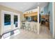 Eat-in kitchen features barstool seating and backyard access to the pool at 508 N Mayo St, Crystal Beach, FL 34681