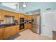 Bright eat-in kitchen featuring wooden cabinets, a breakfast nook, and stainless steel appliances at 508 N Mayo St, Crystal Beach, FL 34681