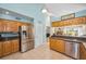 Eat-in kitchen with stainless steel appliances, wooden cabinets, and barstool seating at 508 N Mayo St, Crystal Beach, FL 34681