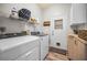 Functional laundry room featuring a washer and dryer, storage shelves, and exterior access, designed for convenience at 508 N Mayo St, Crystal Beach, FL 34681