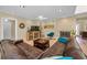 Comfortable living room with a brick fireplace, a plush sofa, and stylish decor at 508 N Mayo St, Crystal Beach, FL 34681