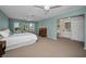 Spacious main bedroom featuring large windows, light blue walls, and adjoining bathroom and walk-in closet at 508 N Mayo St, Crystal Beach, FL 34681