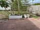 Backyard featuring a red tiled patio and several trees planted in repurposed bathtubs at 5151 Janice Ln, Holiday, FL 34690