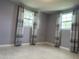 Bedroom showcasing two windows dressed with stylish curtains at 5151 Janice Ln, Holiday, FL 34690