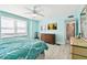 Bright and airy bedroom with light blue walls, comfortable bed, and natural light at 5200 Brittany S Dr # 1502, St Petersburg, FL 33715