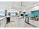 Modern kitchen with white cabinetry, stainless steel appliances, and a functional kitchen island at 5200 Brittany S Dr # 1502, St Petersburg, FL 33715