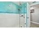 Walk-in shower featuring blue and white tile and modern fixtures at 5200 Brittany S Dr # 1502, St Petersburg, FL 33715