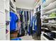Organized walk-in closet with shelving and ample storage space for all of your wardrobe needs at 5200 Brittany S Dr # 1502, St Petersburg, FL 33715