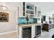 Stylish wet bar with built-in wine storage, unique backsplash, and sophisticated design at 5200 Brittany S Dr # 1502, St Petersburg, FL 33715