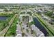 An aerial image displays the property nestled near a pond, with mature trees offering natural beauty and tranquility at 5503 67Th N Ave # 18, Pinellas Park, FL 33781