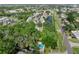 Beautiful aerial view of the property, showcasing lush landscaping, serene pond, and inviting community pool at 5503 67Th N Ave # 18, Pinellas Park, FL 33781