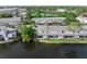 Aerial view of a townhouse complex overlooking a lake, with a walking path in the back at 5503 67Th N Ave # 18, Pinellas Park, FL 33781