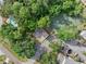 Aerial view of the property featuring lush landscaping, a pool, and a tennis court at 5503 67Th N Ave # 18, Pinellas Park, FL 33781