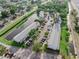 Aerial view of property showing serene pond, parking, and community amenities in a well-maintained neighborhood at 5503 67Th N Ave # 18, Pinellas Park, FL 33781