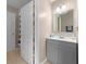Bright bathroom featuring a gray vanity with mirror and a shower at 5503 67Th N Ave # 18, Pinellas Park, FL 33781