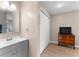 Bathroom featuring a gray vanity, closet, and wood-look floors at 5503 67Th N Ave # 18, Pinellas Park, FL 33781