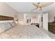 Comfortable bedroom with a ceiling fan, wood headboard, and a patterned bedspread at 5503 67Th N Ave # 18, Pinellas Park, FL 33781