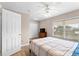 Bedroom features a bed, a ceiling fan, a closet and a window for plenty of natural light at 5503 67Th N Ave # 18, Pinellas Park, FL 33781