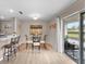 Bright dining area with a glass table, four chairs, wood floors, and sliding doors to a patio at 5503 67Th N Ave # 18, Pinellas Park, FL 33781