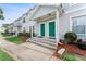 Charming townhouse with green front doors, landscaped bushes, and a concrete walkway at 5503 67Th N Ave # 18, Pinellas Park, FL 33781