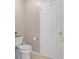 Half-bath with a standard white toilet, roll paper, and a white door at 5503 67Th N Ave # 18, Pinellas Park, FL 33781