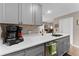 Functional kitchen with gray cabinets, quartz countertops, and stainless steel appliances at 5503 67Th N Ave # 18, Pinellas Park, FL 33781