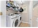 Convenient laundry room with washer, dryer, storage shelves, and a folding area at 5503 67Th N Ave # 18, Pinellas Park, FL 33781
