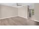 Bright, empty living room featuring wood-look flooring and a ceiling fan at 5503 67Th N Ave # 18, Pinellas Park, FL 33781
