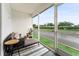 Cozy screened patio featuring comfortable seating, a table, and serene views of the lawn and waterway at 5503 67Th N Ave # 18, Pinellas Park, FL 33781