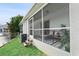 A screened patio offers outdoor seating, a view of the lawn, and space for relaxation and enjoying nature at 5503 67Th N Ave # 18, Pinellas Park, FL 33781