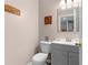Small powder room features a gray vanity with a mirror and a toilet at 5503 67Th N Ave # 18, Pinellas Park, FL 33781