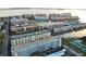 Scenic aerial view of waterfront condos with boat docks on a sunny day, showcasing the waterfront lifestyle at 5935 30Th S Ave # 308, Gulfport, FL 33707