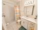 Bright bathroom featuring a tiled shower, white vanity, and modern lighting at 5935 30Th S Ave # 308, Gulfport, FL 33707