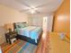 Bright bedroom featuring a ceiling fan, wood floors, and an en suite bathroom at 5935 30Th S Ave # 308, Gulfport, FL 33707