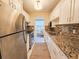 Efficient kitchen with stainless appliances, granite counters and mosaic tile backsplash conveniently located near living areas at 5935 30Th S Ave # 308, Gulfport, FL 33707